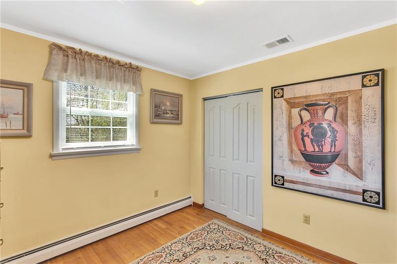 154 Bryson Road Gibsonia, PA 15044 - Photo 23 of 41 a view of an empty room with window and wooden floor
