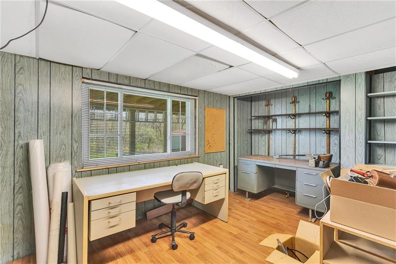 154 Bryson Road Gibsonia, PA 15044 - Photo 26 of 41 a workspace with furniture floor to ceiling window and wooden floor