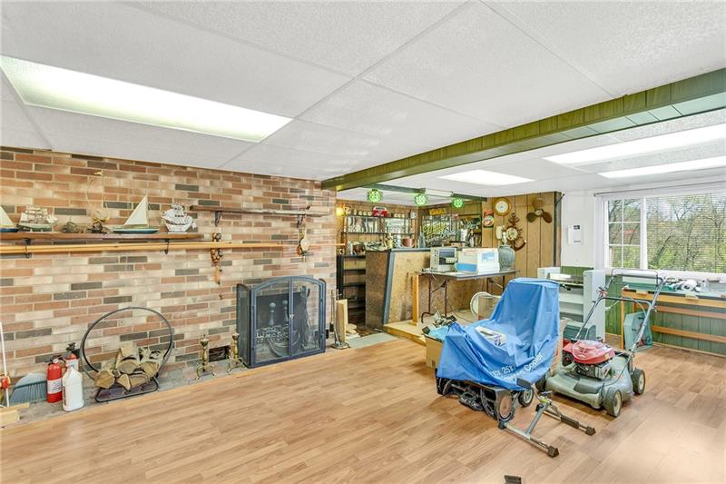 154 Bryson Road Gibsonia, PA 15044 - Photo 29 of 41 a living room with furniture a fireplace and a table