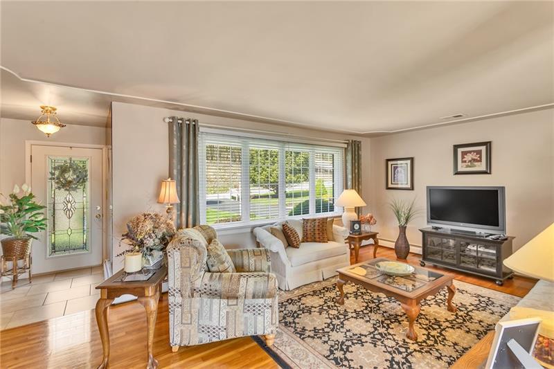 154 Bryson Road Gibsonia, PA 15044 - Photo 6 of 41 a living room with furniture large window and a flat screen tv