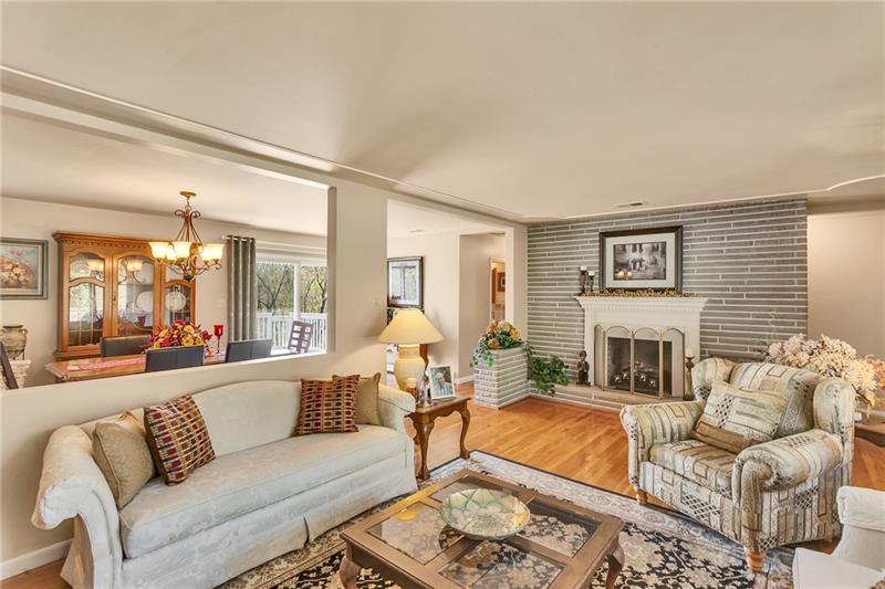 154 Bryson Road Gibsonia, PA 15044 - Photo 7 of 41 a living room with furniture large window and a fireplace