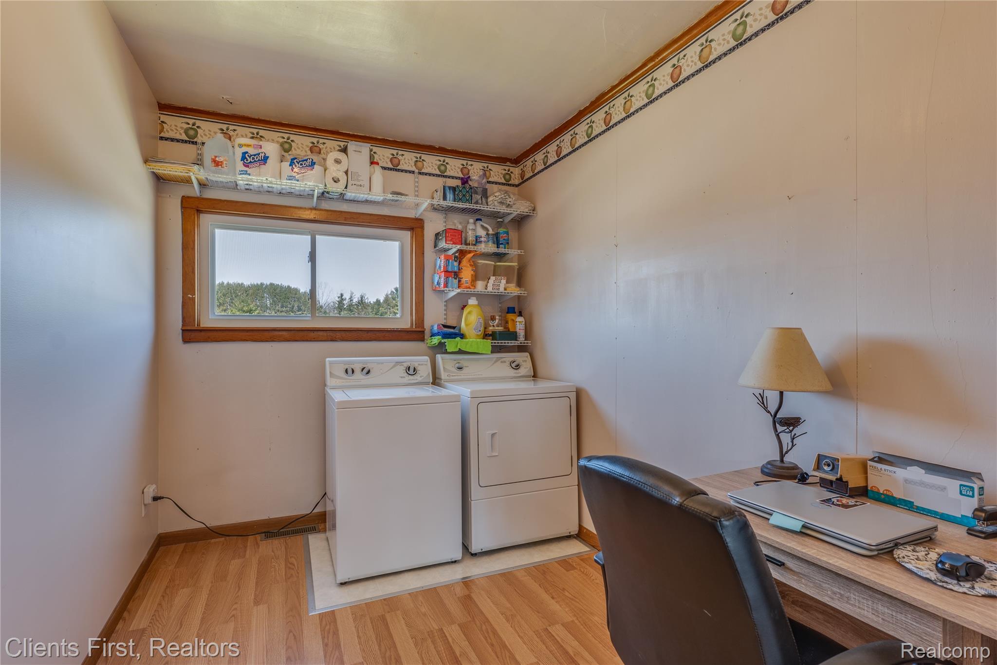 342 North Chambers Road Tawas City, MI 48763 - Photo 21 of 30 Laundry room with light wood-style floors, a desk, and separate washer and dryer