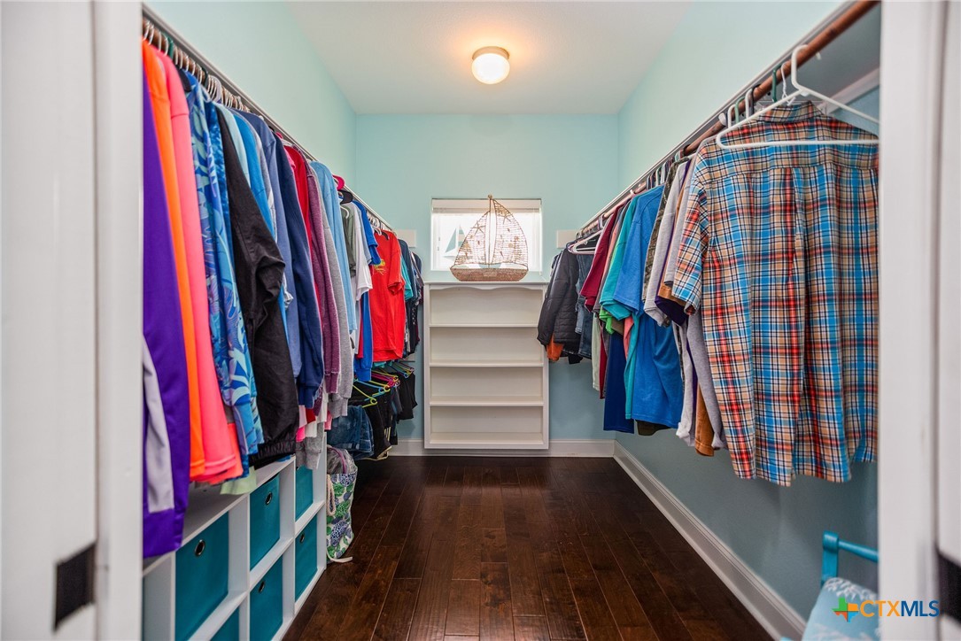 23 Macey Street Port O'Connor, TX 77982 - Photo 35 of 47 a view of walk in closet with clothes and shoes