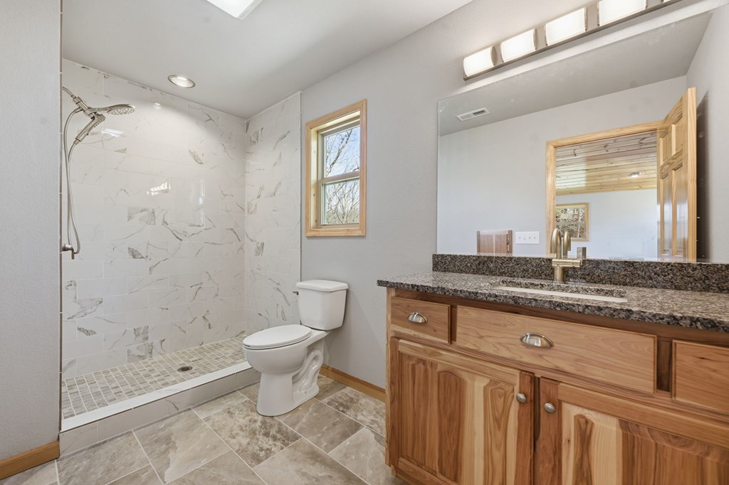 55 Heidis Run Murphy, NC 28906 - Photo 34 of 53 a bathroom with a granite countertop sink a toilet and shower