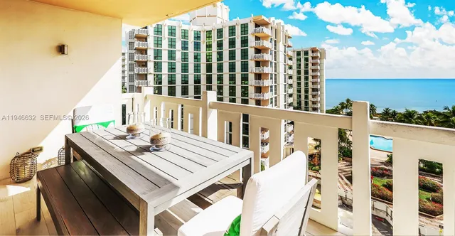 a view of a balcony with a table and chairs