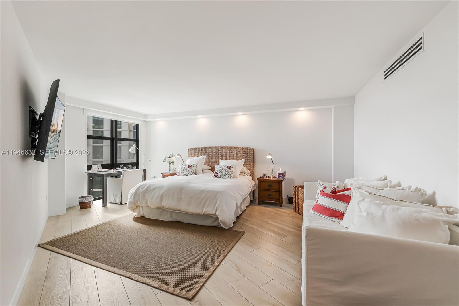 1121 Crandon Boulevard, Unit F802 Key Biscayne, FL 33149 - Photo 14 of 36 a bedroom with a bed and a flat screen tv