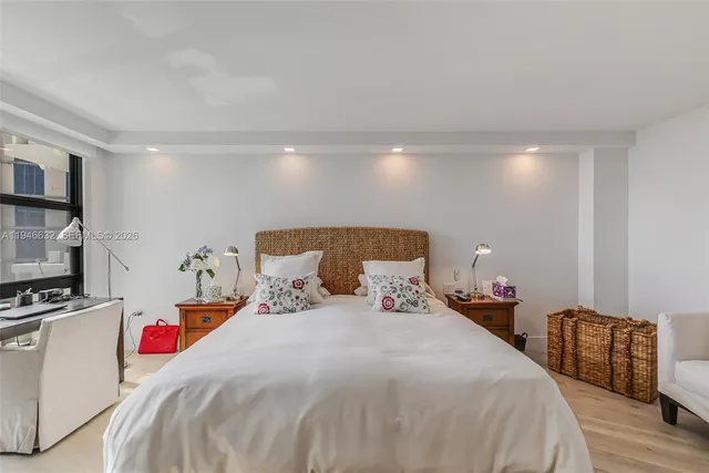 a bedroom with bed and a flat tv screen