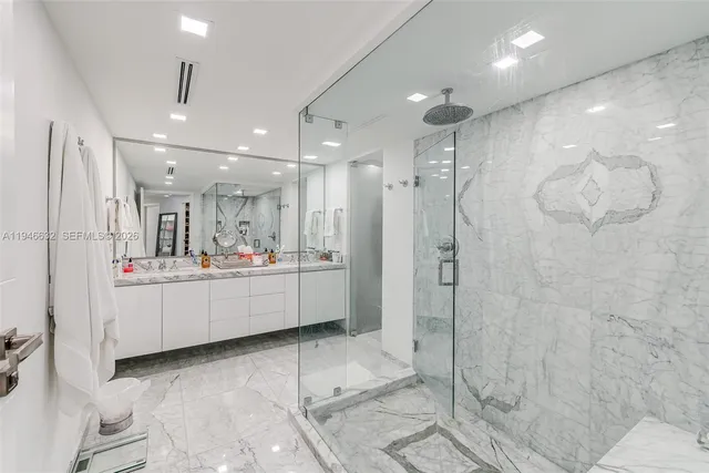 a bathroom with a double vanity sink mirror and shower