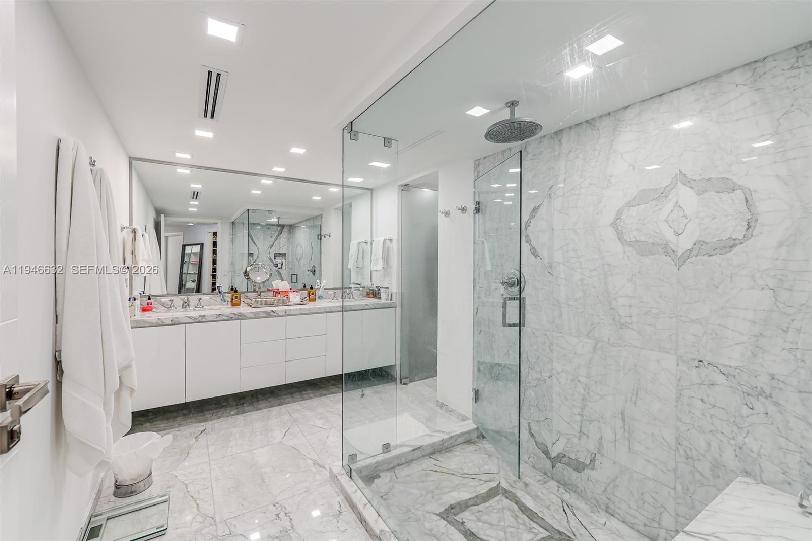 1121 Crandon Boulevard, Unit F802 Key Biscayne, FL 33149 - Photo 17 of 36 a bathroom with a double vanity sink mirror and shower