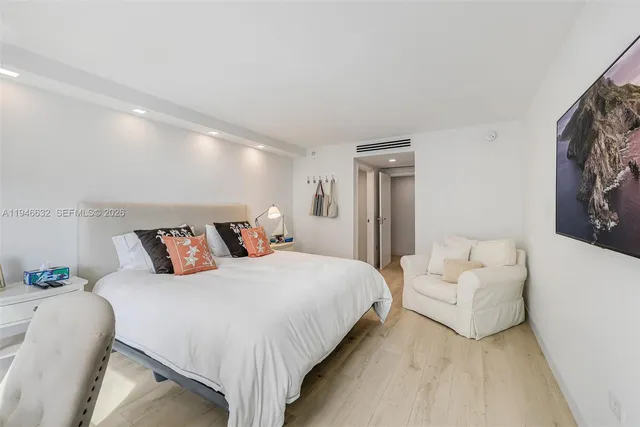 a bedroom with a bed and a couch