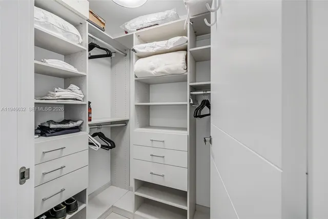 a kitchen with white cabinets and appliances