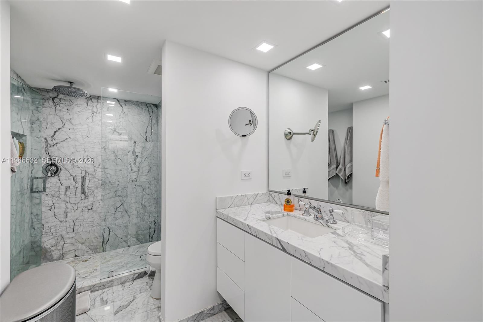 1121 Crandon Boulevard, Unit F802 Key Biscayne, FL 33149 - Photo 21 of 36 a bathroom with a granite countertop sink a toilet and shower
