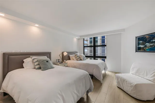 a bedroom with two beds and a couch