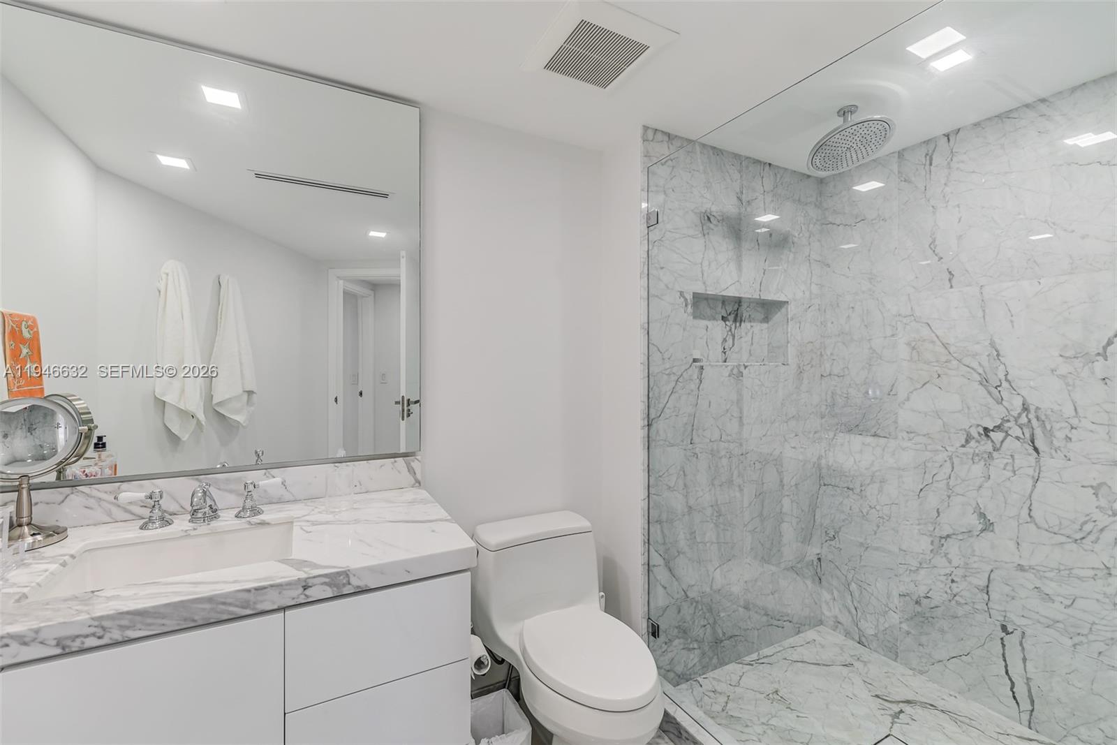 1121 Crandon Boulevard, Unit F802 Key Biscayne, FL 33149 - Photo 24 of 36 a bathroom with a granite countertop sink a toilet and shower
