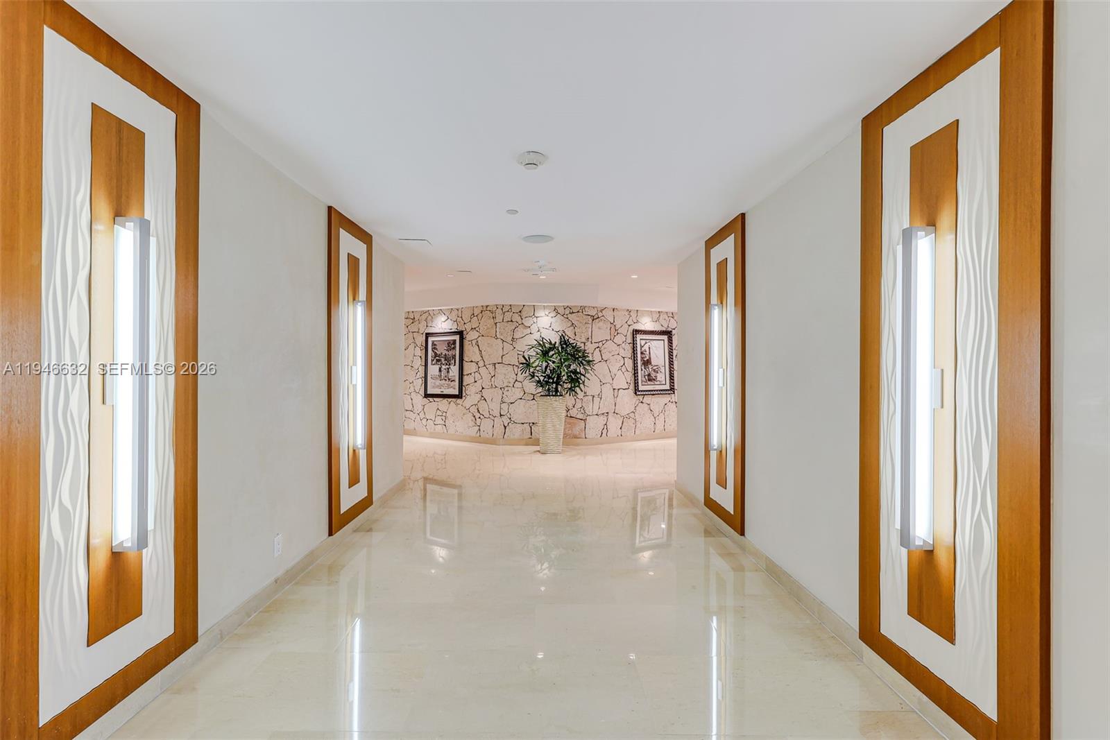 1121 Crandon Boulevard, Unit F802 Key Biscayne, FL 33149 - Photo 31 of 36 a view of a hallway with windows and plants