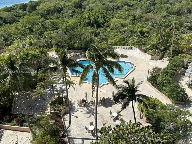 a view of backyard of a house with outdoor seating