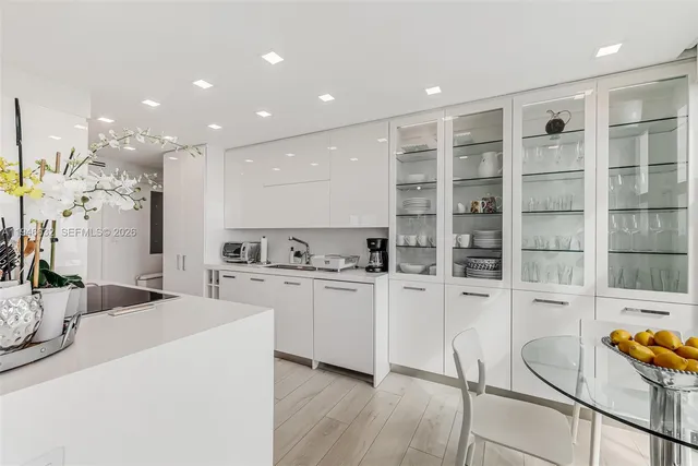 a kitchen with stainless steel appliances kitchen island granite countertop a sink and cabinets