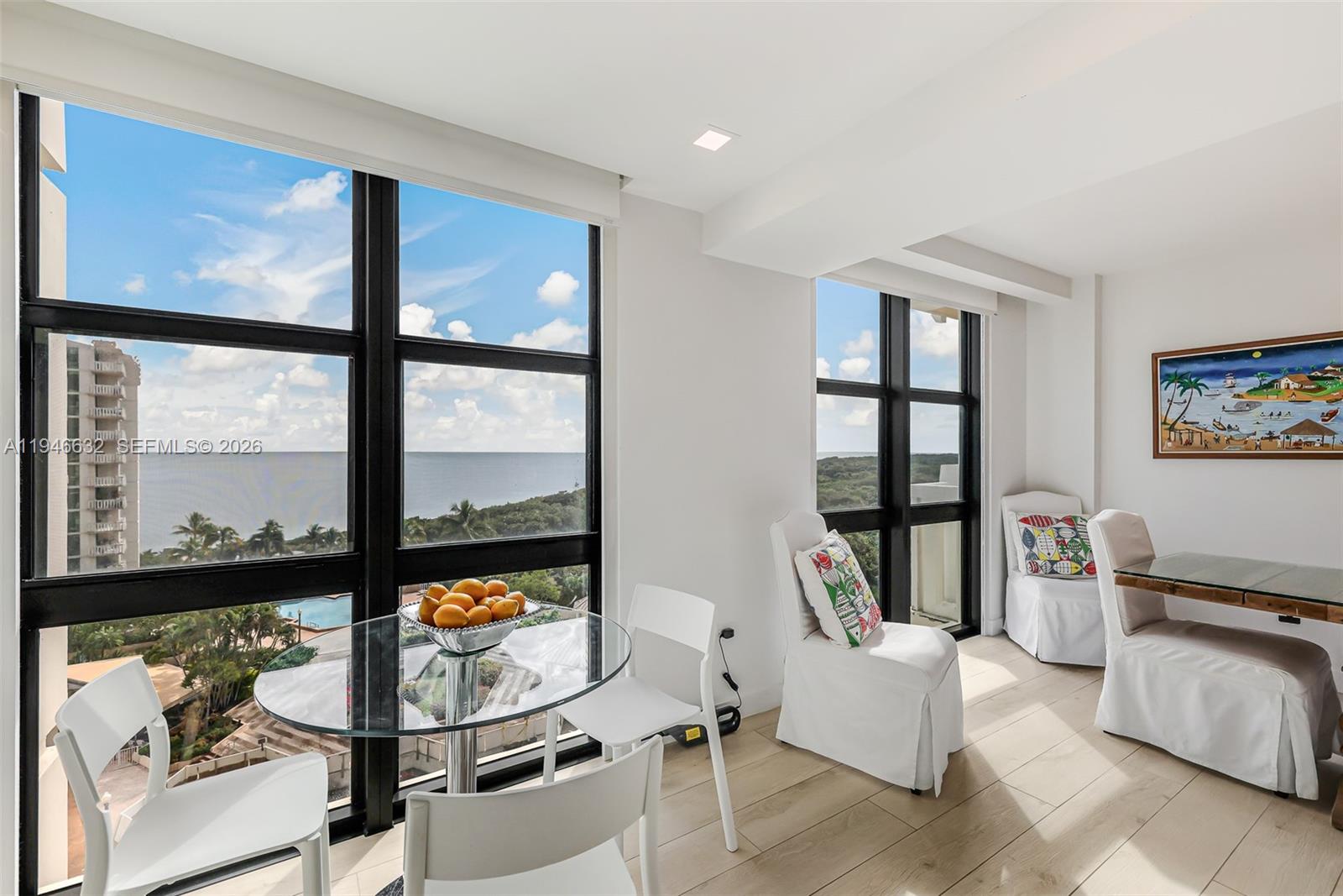 1121 Crandon Boulevard, Unit F802 Key Biscayne, FL 33149 - Photo 10 of 36 a living room with furniture and a floor to ceiling window