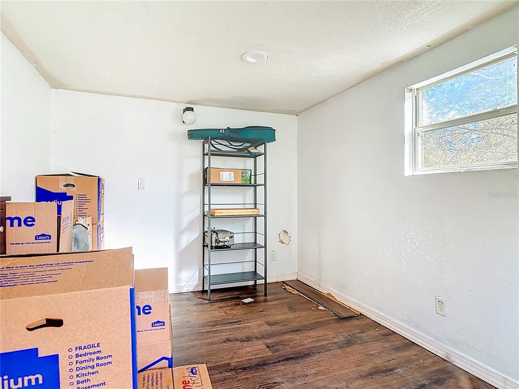 43430 Cooter Pond Road DeLand, FL 32720 - Photo 14 of 37 an empty room with wooden floor and closet