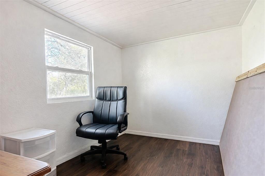 43430 Cooter Pond Road DeLand, FL 32720 - Photo 17 of 37 a view of a room with wooden floor lounge chair and windows