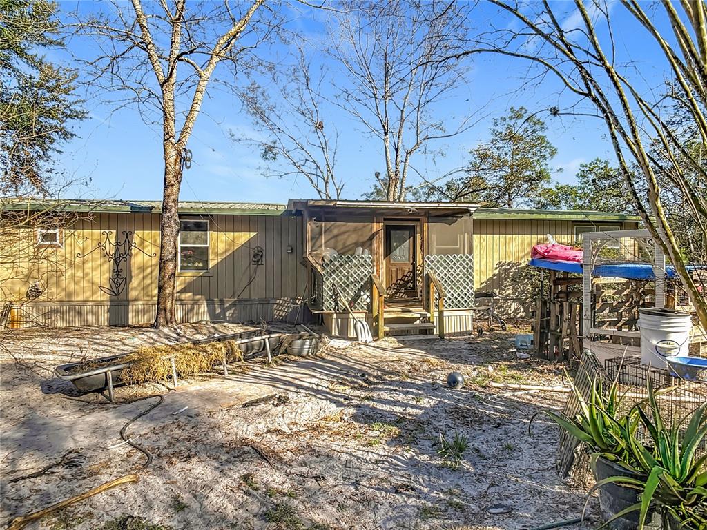 43430 Cooter Pond Road DeLand, FL 32720 - Photo 2 of 37 a view of a house with wooden floor and a large tree