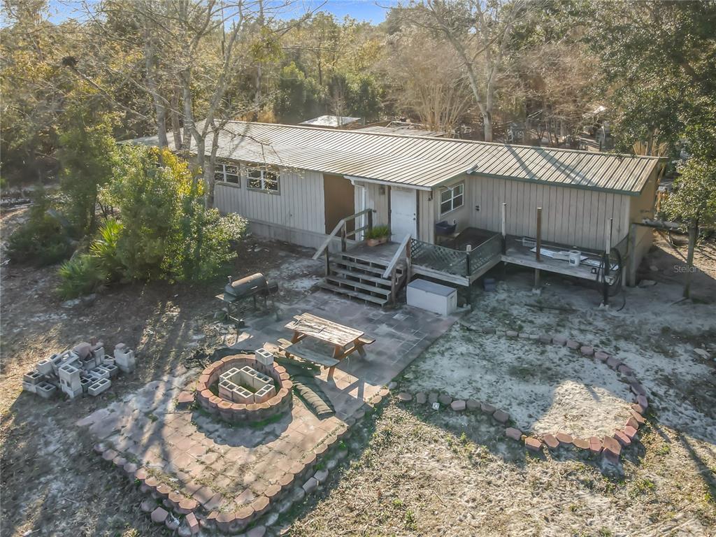 43430 Cooter Pond Road DeLand, FL 32720 - Photo 30 of 37 a view of a table and chairs in the yard