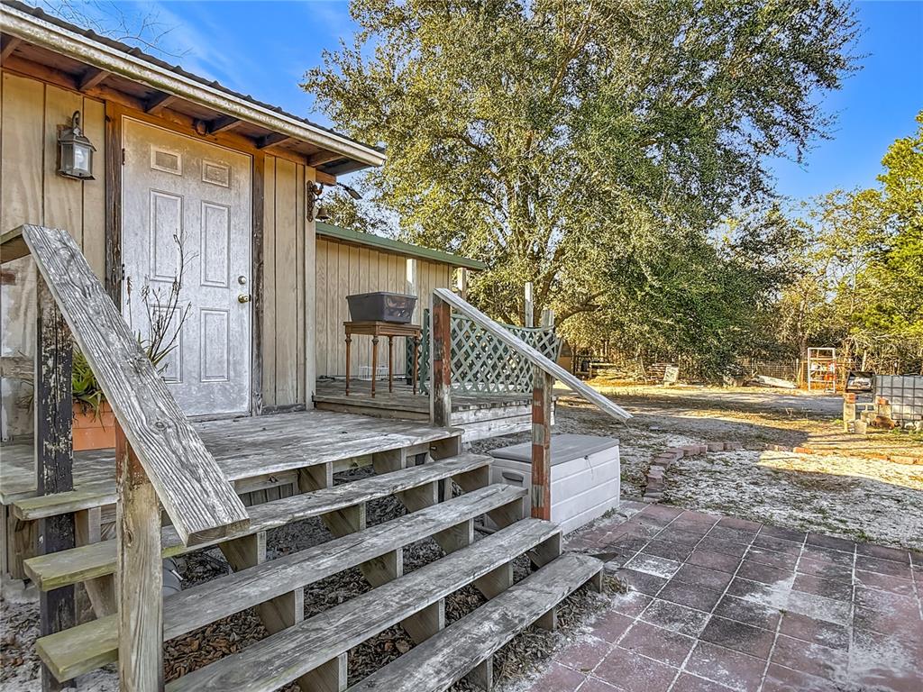 43430 Cooter Pond Road DeLand, FL 32720 - Photo 3 of 37 a view of house with outdoor space and wooden deck