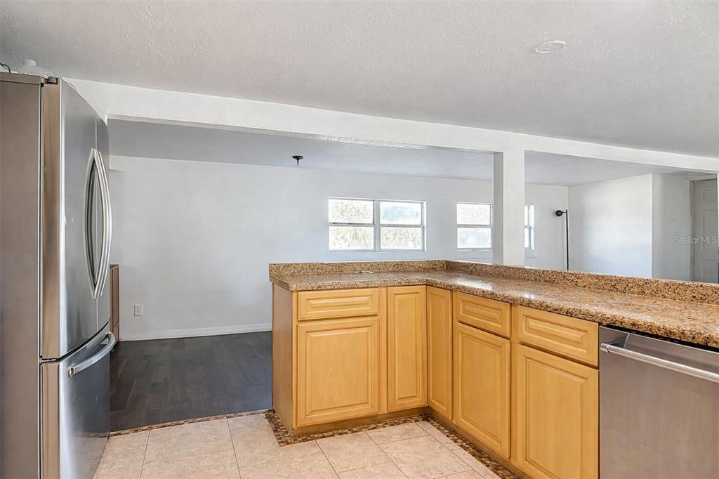 43430 Cooter Pond Road DeLand, FL 32720 - Photo 5 of 37 a view of a kitchen with granite countertop a refrigerator and a sink