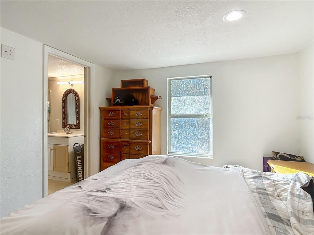 43430 Cooter Pond Road DeLand, FL 32720 - Photo 9 of 37 a bedroom with a bed and a dresser