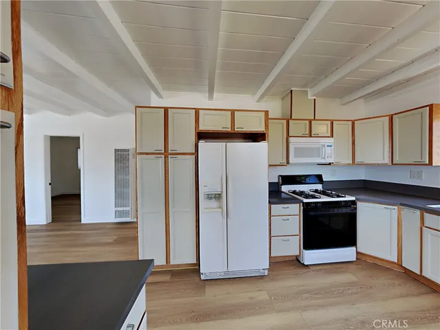a kitchen with stainless steel appliances a stove a refrigerator and a sink