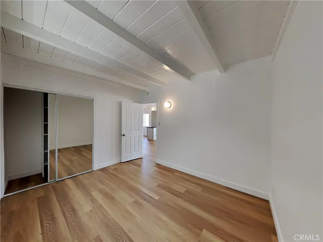 a view of an empty room and wooden floor