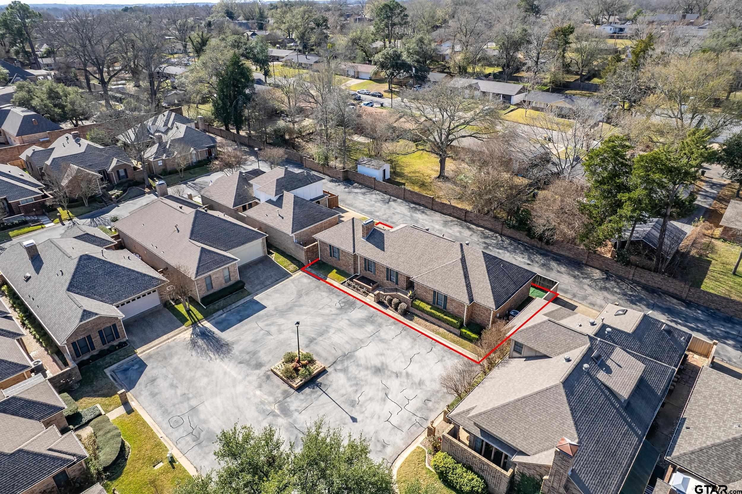 an aerial view of a house with a yard