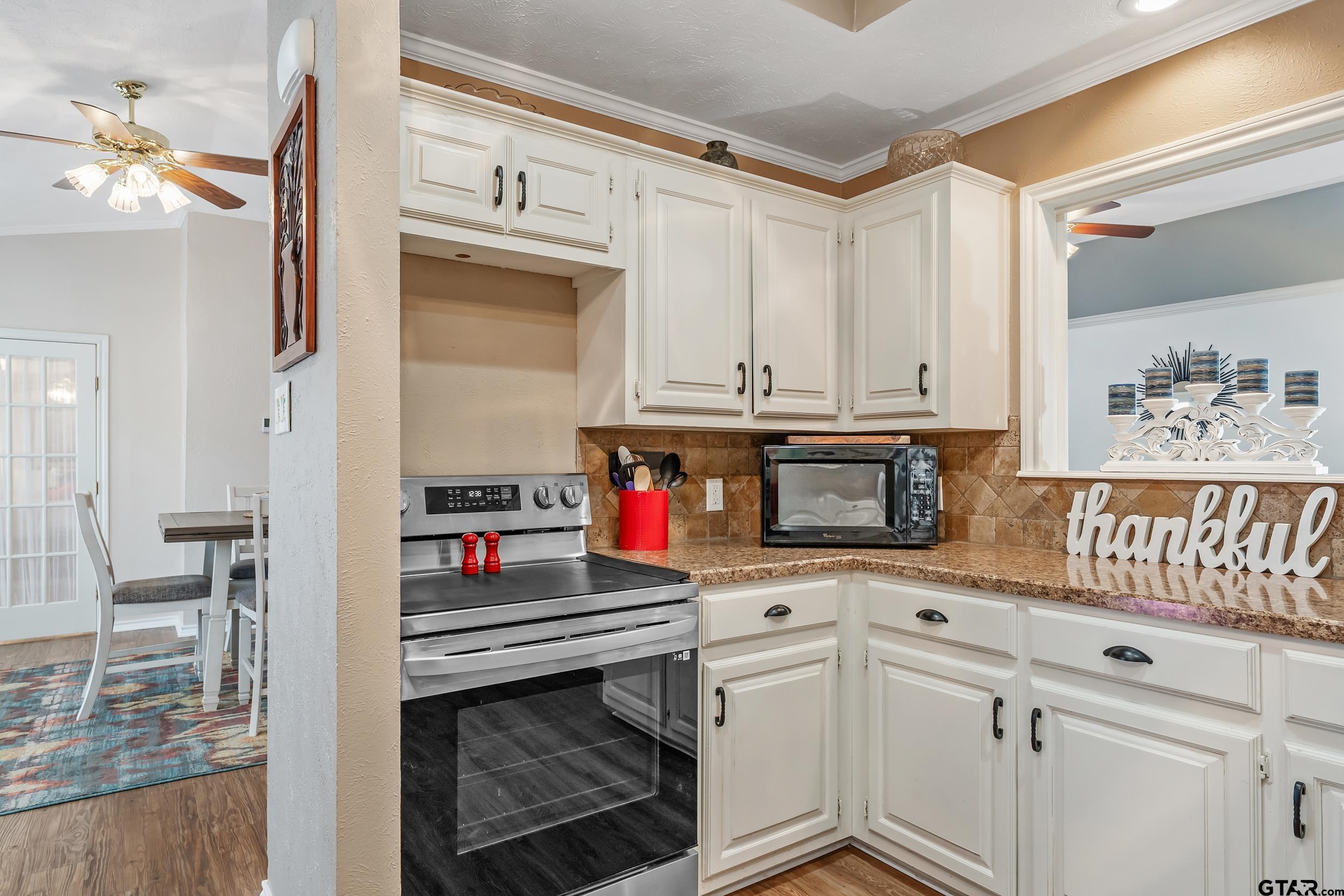 3309 Trafalgar Square Tyler, TX 75701 - Photo 11 of 23 a kitchen with stainless steel appliances granite countertop a stove and a microwave
