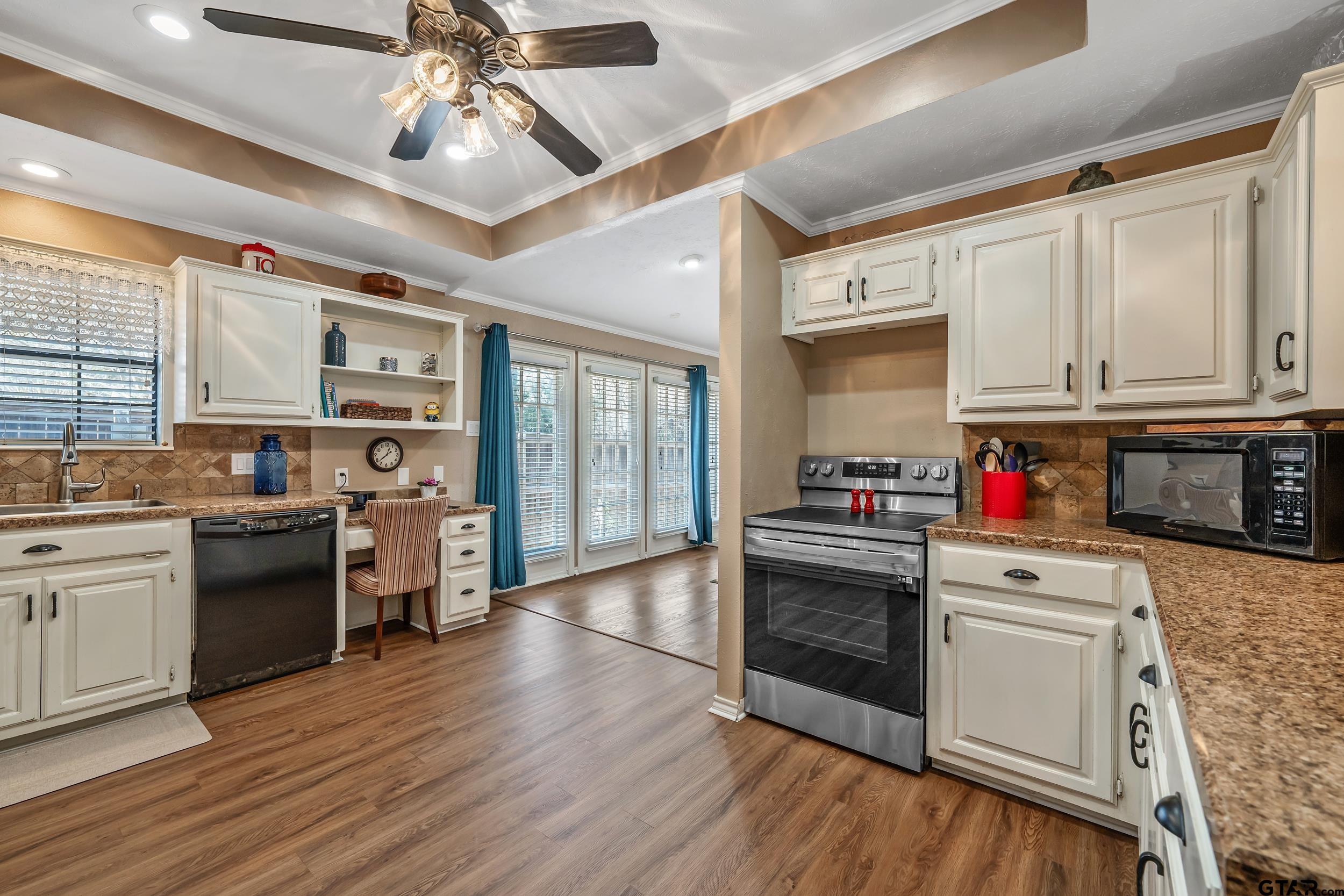 3309 Trafalgar Square Tyler, TX 75701 - Photo 12 of 23 a kitchen with stainless steel appliances kitchen island granite countertop a stove and a refrigerator