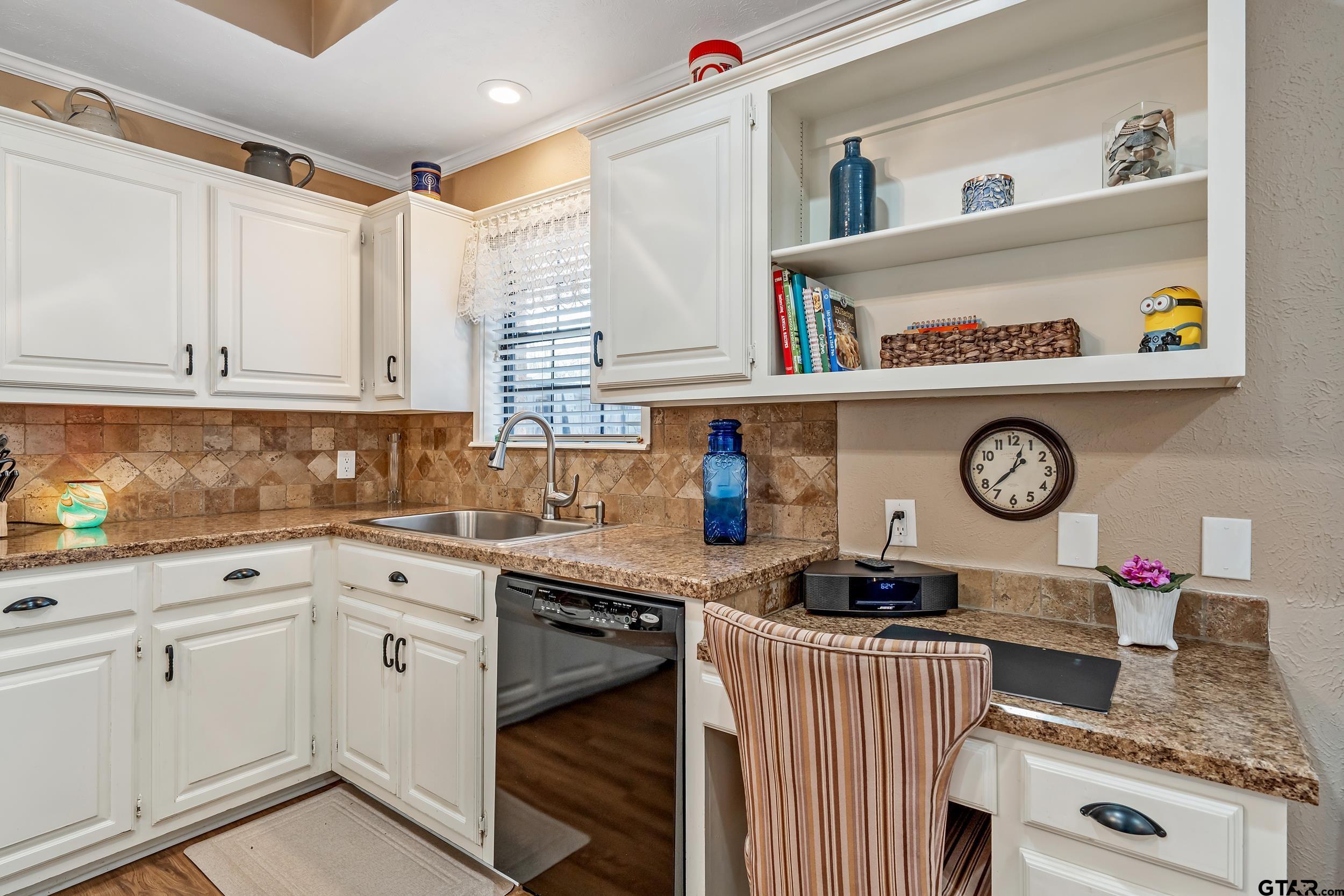 3309 Trafalgar Square Tyler, TX 75701 - Photo 10 of 23 a kitchen with granite countertop a stove a sink and cabinets
