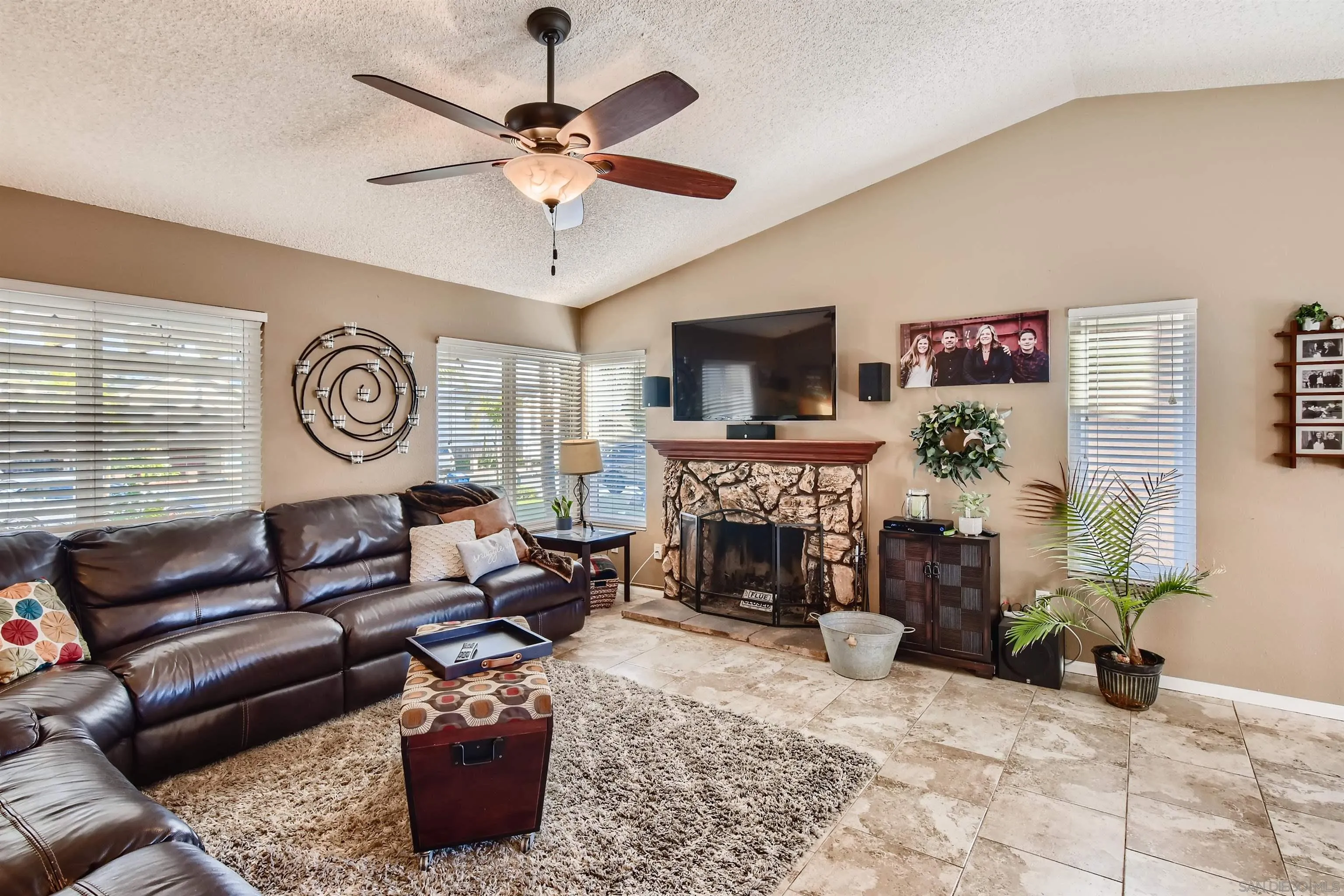 10218 Pebble Beach Drive Santee, CA 92071 - Photo 7 of 28 a living room with furniture a fireplace and a flat screen tv