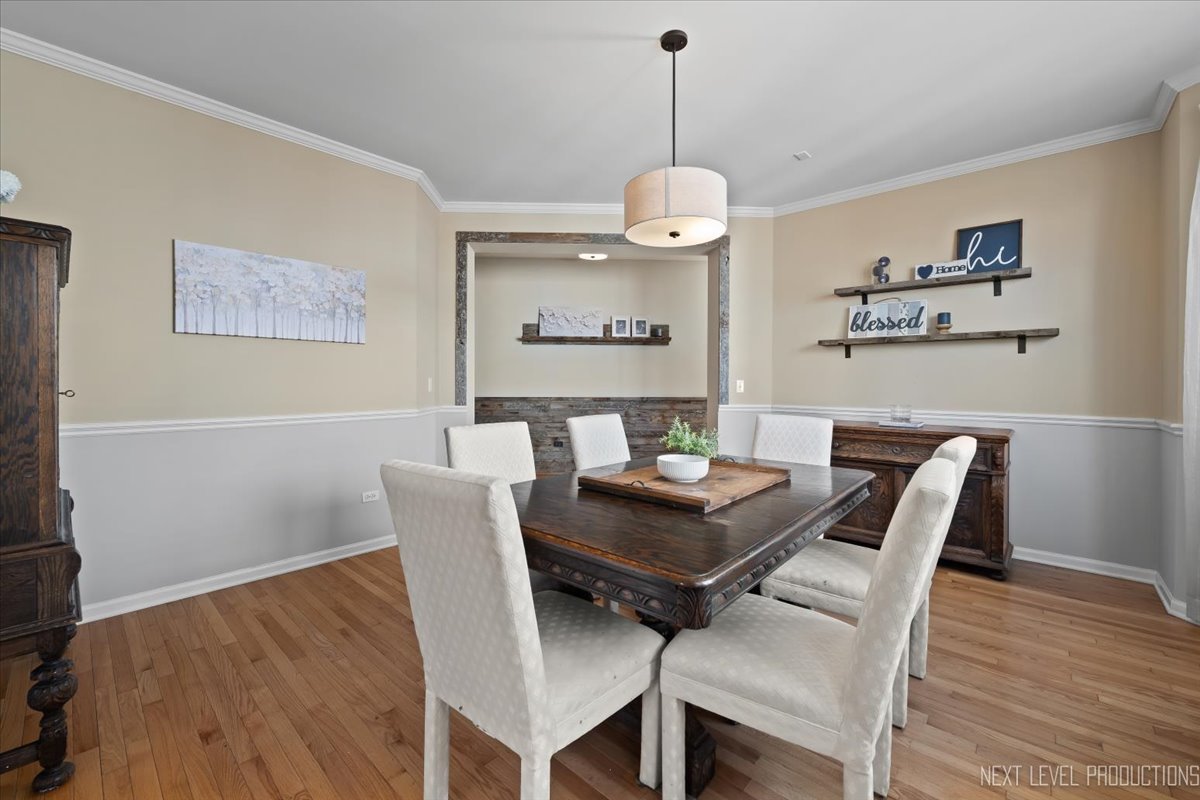 3520 Timber Creek Lane Naperville, IL 60565 - Photo 12 of 50 a view of a dining room with furniture wooden floor and a chandelier