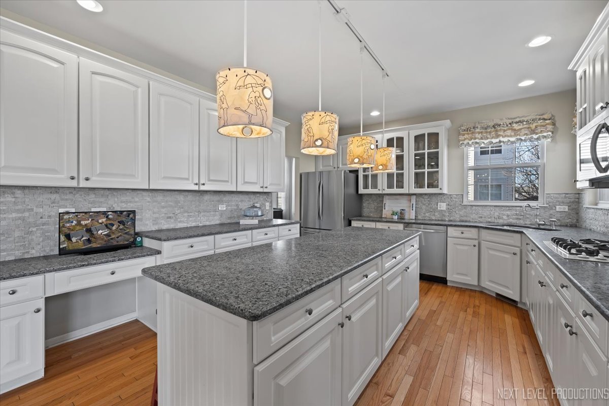 3520 Timber Creek Lane Naperville, IL 60565 - Photo 2 of 50 a kitchen with stainless steel appliances granite countertop a sink dishwasher stove and refrigerator with wooden floor