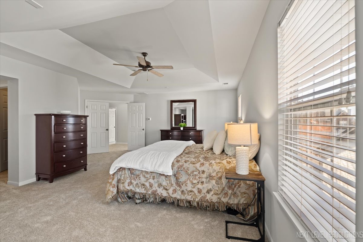3520 Timber Creek Lane Naperville, IL 60565 - Photo 23 of 50 a bedroom with a bed and a chandelier