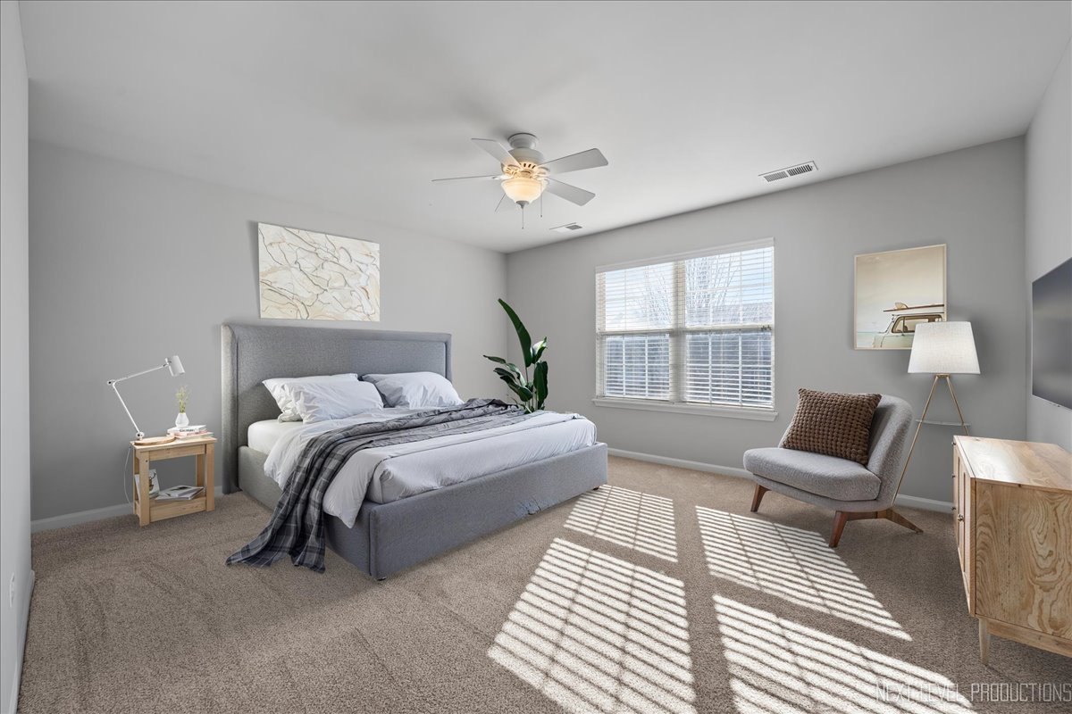 3520 Timber Creek Lane Naperville, IL 60565 - Photo 25 of 50 a spacious bedroom with a bed a couch and a large window