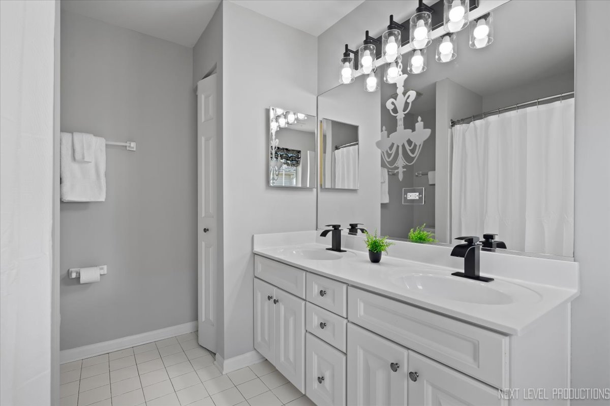 3520 Timber Creek Lane Naperville, IL 60565 - Photo 29 of 50 a bathroom with a sink a vanity a mirror and shower view