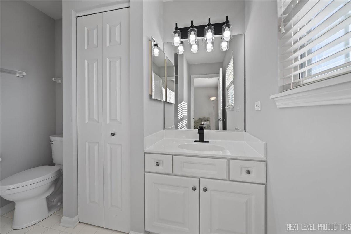 3520 Timber Creek Lane Naperville, IL 60565 - Photo 30 of 50 a bathroom with a toilet sink and mirror