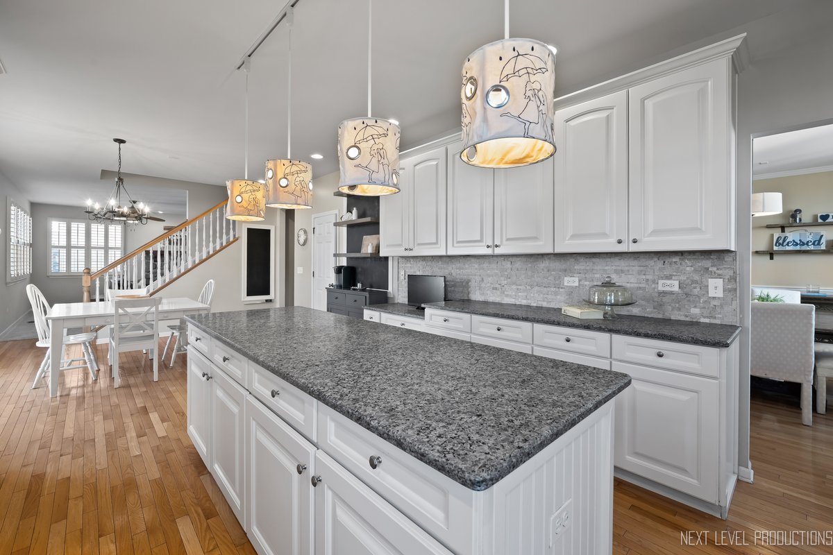 3520 Timber Creek Lane Naperville, IL 60565 - Photo 3 of 50 a kitchen with stainless steel appliances granite countertop a kitchen island a stove and a wooden floors