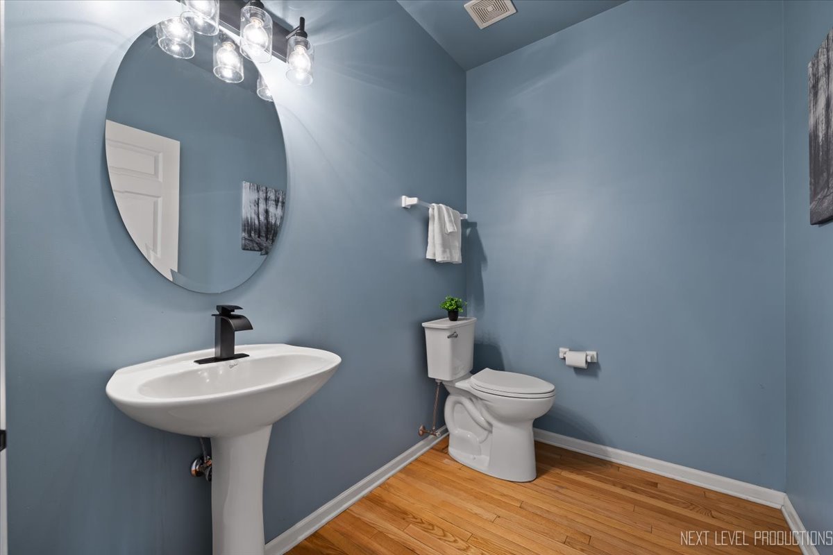 3520 Timber Creek Lane Naperville, IL 60565 - Photo 32 of 50 a bathroom with a toilet sink and mirror