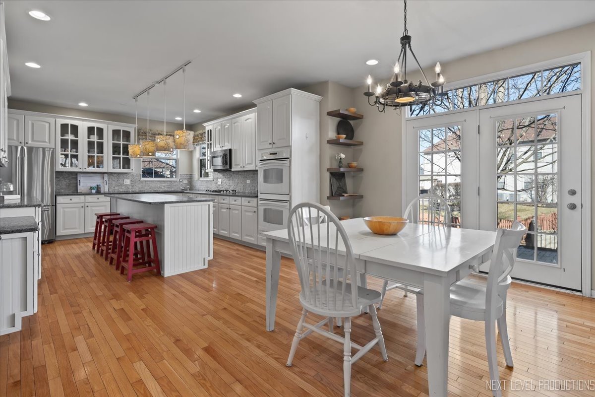 3520 Timber Creek Lane Naperville, IL 60565 - Photo 6 of 50 a kitchen with stainless steel appliances kitchen island granite countertop a table chairs and a refrigerator