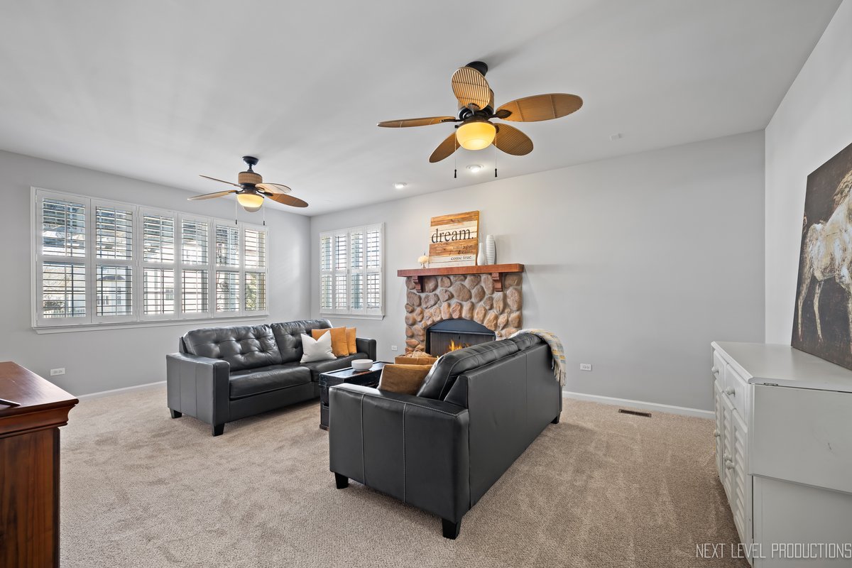 3520 Timber Creek Lane Naperville, IL 60565 - Photo 9 of 50 a living room with furniture a fireplace and a large window