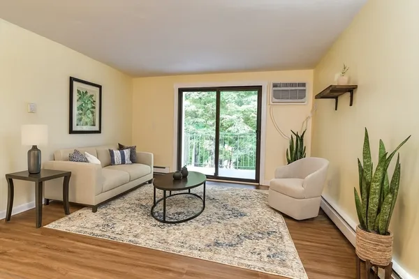 a living room with furniture and a large window