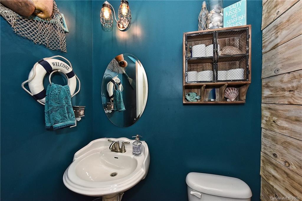 3004 Fallondale Road, Unit 906 Waxhaw, NC 28173 - Photo 12 of 24 a bathroom with a toilet sink and mirror
