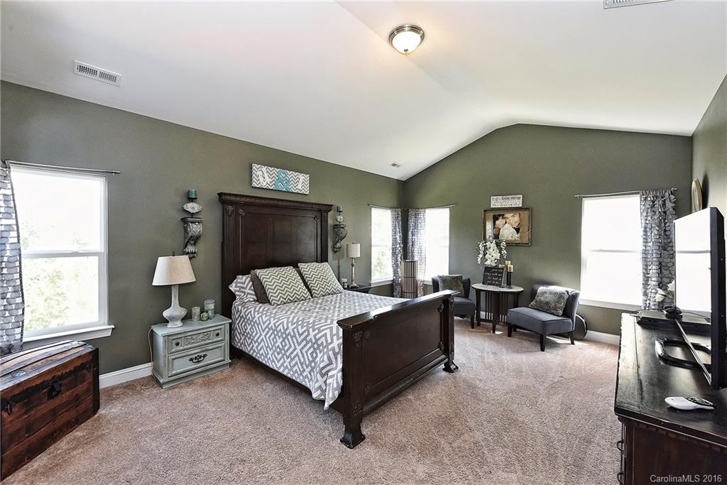 3004 Fallondale Road, Unit 906 Waxhaw, NC 28173 - Photo 13 of 24 a bedroom with a bed and furniture