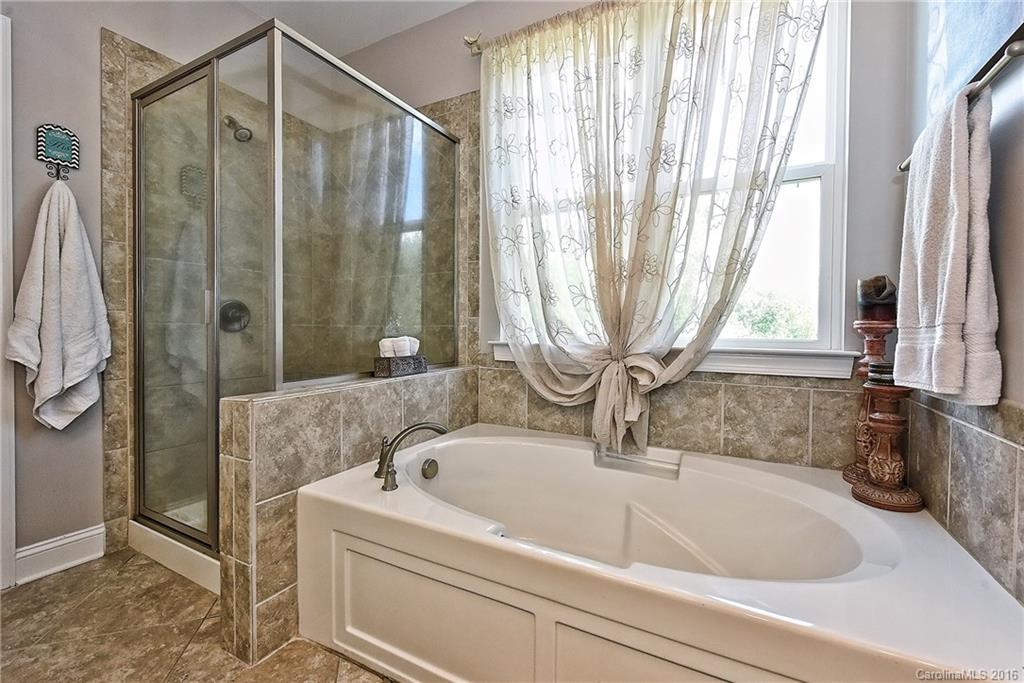 3004 Fallondale Road, Unit 906 Waxhaw, NC 28173 - Photo 15 of 24 a bathroom with a bathtub and shower